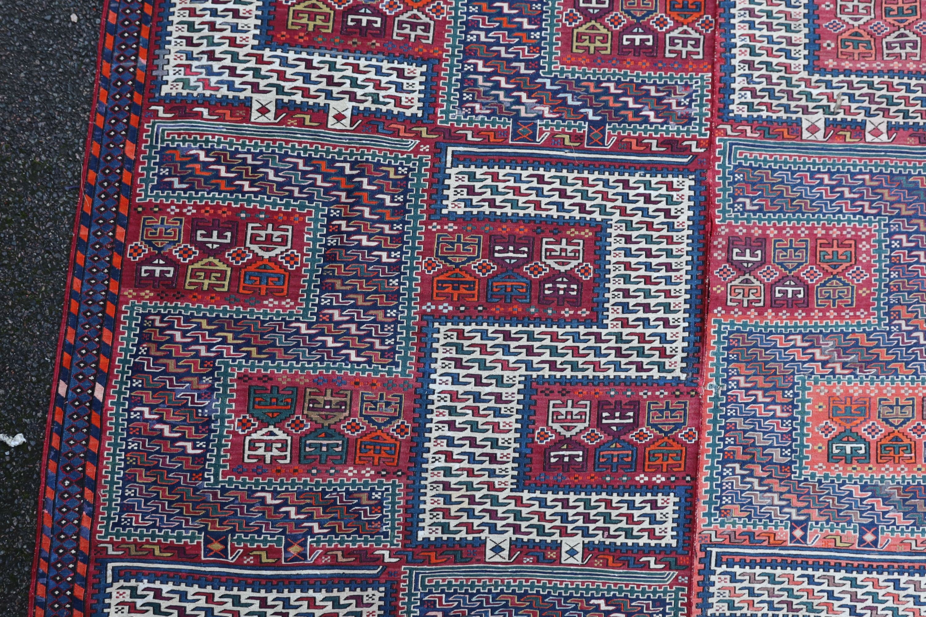 A Sumak weave 2-sectional carpet, combined dimension - 320 x 230cm.